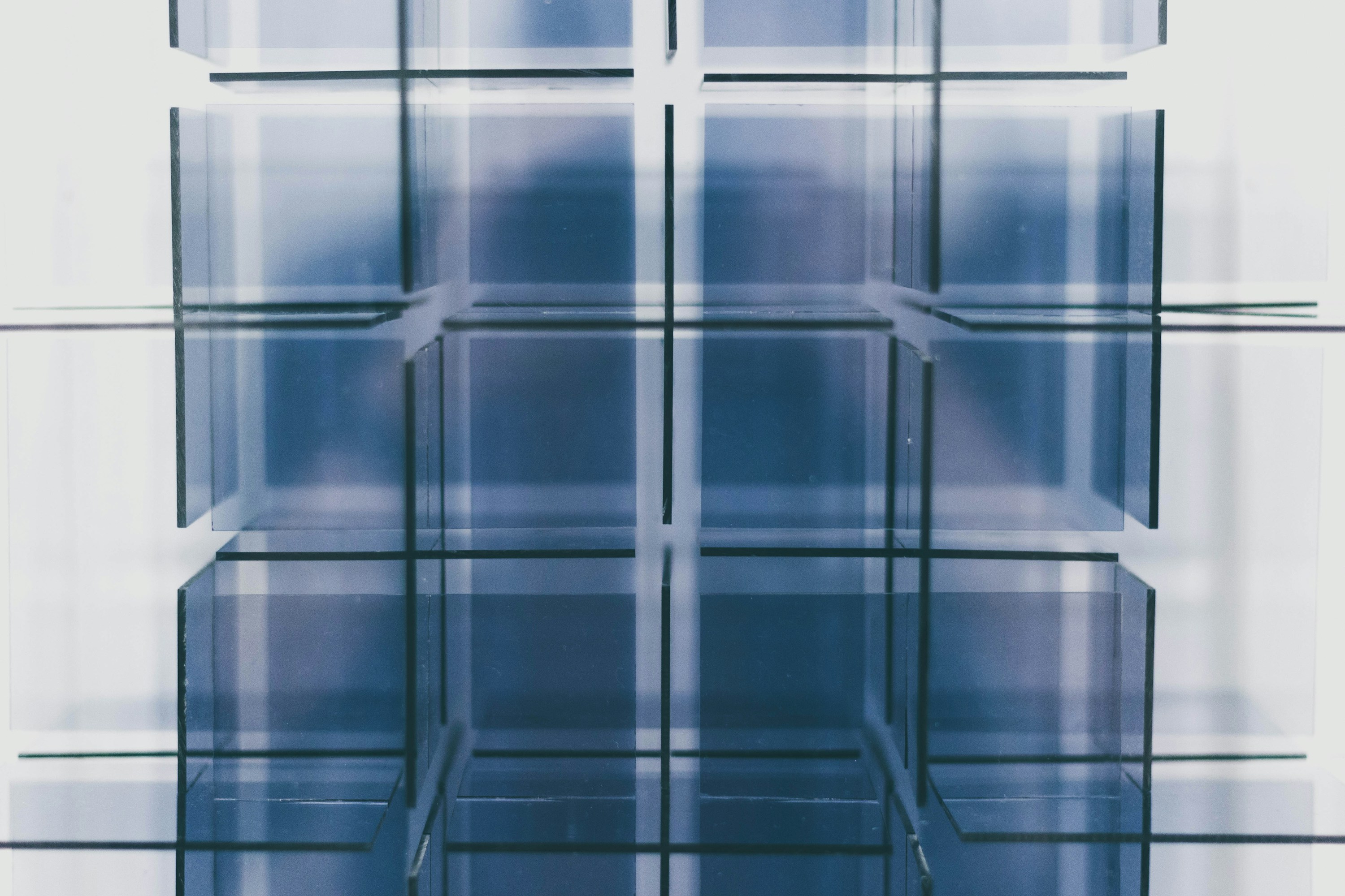 A real glass installation composed of repeated transparent blue structures