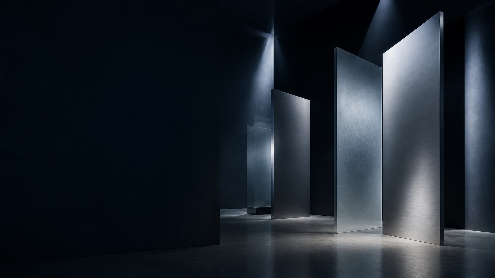 Distinct silver architectural planes arranged within one dark gallery environment